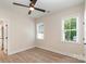 Bright bedroom with contemporary ceiling fan and two windows, offering natural light at 5162 Beckenham Ln, Concord, NC 28025