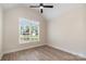 A sunlit room features a modern ceiling fan and a large window with neighborhood views at 5162 Beckenham Ln, Concord, NC 28025