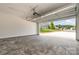 View from inside the garage, with modern door, looking out on a well maintained lawn and neighborhood homes at 5162 Beckenham Ln, Concord, NC 28025