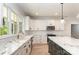 Beautiful kitchen featuring granite countertops, stainless appliances, and modern hanging lights at 5162 Beckenham Ln, Concord, NC 28025