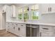 Modern kitchen featuring white cabinets, granite countertops, and stainless steel appliances at 5162 Beckenham Ln, Concord, NC 28025