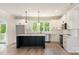 Bright kitchen with white cabinetry, stainless steel appliances, and a dark-stained island at 5162 Beckenham Ln, Concord, NC 28025