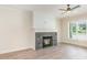 Cozy living room features a stone fireplace, wood floors, and natural light from the window at 5162 Beckenham Ln, Concord, NC 28025
