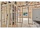 The wood frame of a bathroom, showcasing the early stages of the room's layout with window and plumbing visible during construction at 530 Gantt St, Mooresville, NC 28115