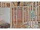 Unfinished bathroom featuring exposed framing, pink insulation, open shower, and plumbing at 530 Gantt St, Mooresville, NC 28115