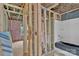 Unfinished bathroom featuring exposed framing, plumbing, pink insulation, and open shower at 530 Gantt St, Mooresville, NC 28115