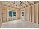 Bedroom is unfinished and shows the exposed studs, rough flooring, one window and a door at 530 Gantt St, Mooresville, NC 28115