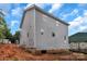 A back corner view of a two story house, focusing on its gray siding against a cloudy sky at 530 Gantt St, Mooresville, NC 28115