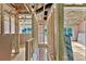 Unfinished hallway featuring exposed framing, pink insulation, and exterior view windows at 530 Gantt St, Mooresville, NC 28115