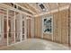 Interior view showcasing the wooden framework during construction with a window, plumbing, and electrical during building process at 530 Gantt St, Mooresville, NC 28115