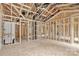 An open-concept interior view during framing, revealing wooden structure with installed plumbing and ductwork during building process at 530 Gantt St, Mooresville, NC 28115