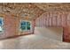Unfinished room featuring exposed framing, pink insulation, and exterior view windows at 530 Gantt St, Mooresville, NC 28115