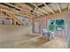 Unfinished room with exposed framing, pink insulation, OSB subfloor, and a door to the exterior at 530 Gantt St, Mooresville, NC 28115