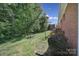 Spacious backyard with lush green grass and mature trees providing shade at 5938 Mundy Rd, Denver, NC 28037