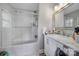 Bathroom featuring a shower-tub combo with glass doors, white vanity, and updated fixtures at 5938 Mundy Rd, Denver, NC 28037