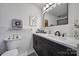 Well-lit bathroom featuring a double vanity, large mirror, and stylish decor at 5938 Mundy Rd, Denver, NC 28037