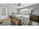 Bedroom with bright natural light, ceiling fan, wood floors, and neutral decor at 5938 Mundy Rd, Denver, NC 28037