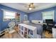 Cozy bedroom with blue walls, wood flooring, and a ceiling fan for added comfort at 5938 Mundy Rd, Denver, NC 28037