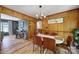 Inviting dining area with stylish chairs, a bright lighting fixture, and wood-paneled walls at 5938 Mundy Rd, Denver, NC 28037