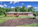 Charming brick home with a well-kept lawn, tasteful landscaping, and an attached garage, offering a welcoming curb appeal at 5938 Mundy Rd, Denver, NC 28037