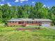 Well-maintained brick home featuring a manicured lawn, mature trees, and an attached garage, showcasing curb appeal at 5938 Mundy Rd, Denver, NC 28037