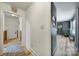 Bright hallway with modern vinyl flooring, featuring a decorative mirror and an inviting 'Welcome' sign at 5938 Mundy Rd, Denver, NC 28037