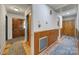 Inviting hallway with wood-paneled walls, a closet, and stylish flooring leading to a front door at 5938 Mundy Rd, Denver, NC 28037