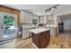 Modern kitchen featuring white cabinets, a center island, stainless steel appliances, and ample counter space at 5938 Mundy Rd, Denver, NC 28037