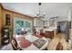 Bright kitchen featuring a dining table, white cabinets, an island, and modern lighting fixtures at 5938 Mundy Rd, Denver, NC 28037