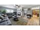 Cozy living room with fireplace, gray sectional sofa, wood floors, and lots of natural light at 5938 Mundy Rd, Denver, NC 28037