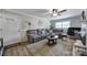 Comfortable living room with a large gray sectional sofa, area rug, and ample natural light at 5938 Mundy Rd, Denver, NC 28037