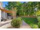 A landscaped backyard with a wooden fence, patio, and lush lawn at 6002 Sentinel Dr, Indian Trail, NC 28079