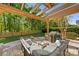Inviting backyard patio with pergola, outdoor seating, and fire pit at 6002 Sentinel Dr, Indian Trail, NC 28079