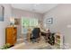 Inviting bedroom with a well-placed desk, chair, and lots of natural light at 6002 Sentinel Dr, Indian Trail, NC 28079
