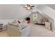 Spacious bonus room with sloped ceilings, a sofa, bed, and ceiling fan at 6002 Sentinel Dr, Indian Trail, NC 28079