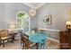 Bright dining room featuring an arched window, modern lighting, and comfortable seating at 6002 Sentinel Dr, Indian Trail, NC 28079