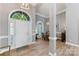 Open foyer featuring a beautiful arched window, wood floors, and a dining area at 6002 Sentinel Dr, Indian Trail, NC 28079