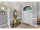 Bright foyer with a tall ceiling, arched window over the door, and hardwood floors at 6002 Sentinel Dr, Indian Trail, NC 28079