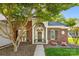 Close-up of the front door of a brick home with beautiful landscaping and a welcoming entrance at 6002 Sentinel Dr, Indian Trail, NC 28079