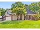 Charming brick home featuring a well-manicured lawn and beautiful landscaping at 6002 Sentinel Dr, Indian Trail, NC 28079
