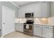 Well-equipped kitchen featuring white cabinets, stainless steel range, and bright lighting for a functional cooking space at 6002 Sentinel Dr, Indian Trail, NC 28079