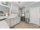 Updated kitchen with white cabinets, stainless steel appliances, and a view into the living area for easy interaction at 6002 Sentinel Dr, Indian Trail, NC 28079