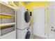 Functional laundry room equipped with modern washer and dryer, storage shelves, and convenient access to the outdoors at 6002 Sentinel Dr, Indian Trail, NC 28079