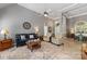 Spacious living room with high ceilings, a ceiling fan, comfortable seating, and seamless flow into the dining area at 6002 Sentinel Dr, Indian Trail, NC 28079