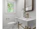 Bright bathroom featuring a square sink with gold hardware, mirror, toilet, and window at 625 4Th Street Nw Dr, Hickory, NC 28601