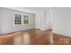 Light-filled bedroom with hardwood floors features two windows, a door, and ample space at 625 4Th Street Nw Dr, Hickory, NC 28601