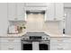 Kitchen featuring stainless steel range and hood, marble counters, and white cabinets at 625 4Th Street Nw Dr, Hickory, NC 28601