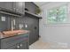 Laundry room with butcher block counter, dark cabinets, and natural light from window at 625 4Th Street Nw Dr, Hickory, NC 28601