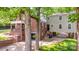 View of the rear of the home with covered patio, garage, mature trees, and access to additional living space at 625 4Th Street Nw Dr, Hickory, NC 28601