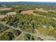 An aerial view shows the lot lines for this parcel of land, which is mostly wooded, in a rural area at 6312 Bill Ledford Rd, Vale, NC 28168